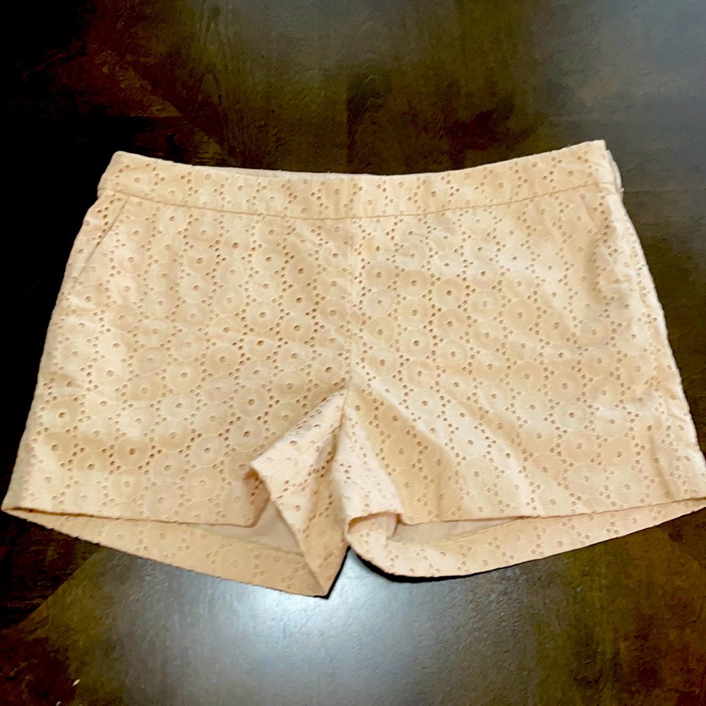Cream colored eyelet Cotten lined shorts.